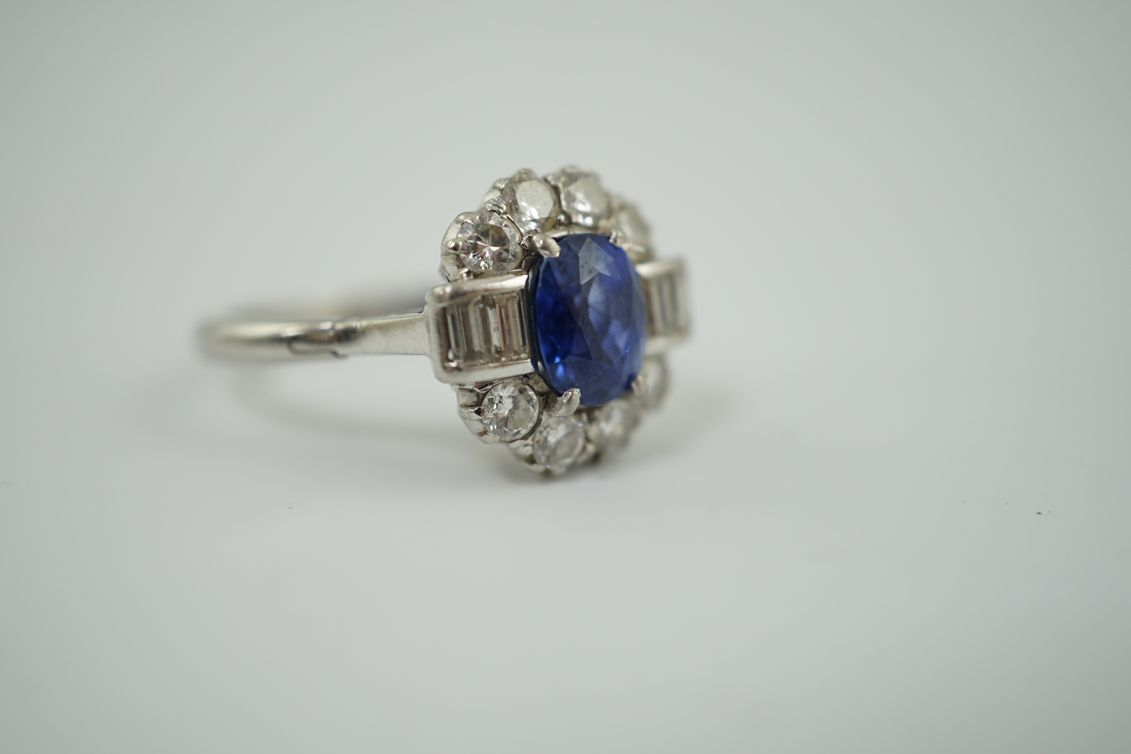 An Art Deco style platinum?, sapphire and diamond cluster ring